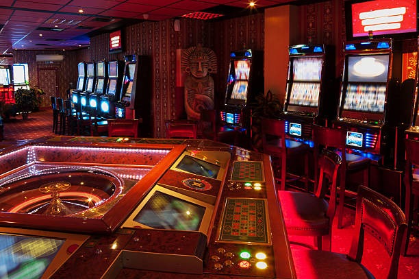 Live dealer rolling three dice in Sic Bo game